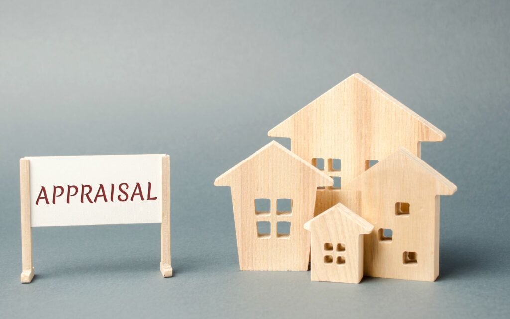 A Business Appraisal Services sign next to a miniature wooden houses