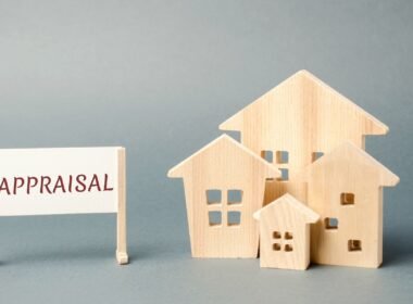 A Business Appraisal Services sign next to a miniature wooden houses