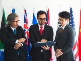 A group of professionals from diverse backgrounds collaborating in a meeting room