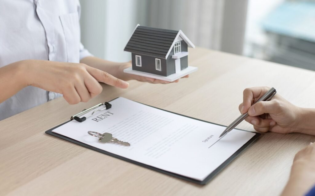 Landlord holding rental keys and business license document, illustrating the licensing requirements for renting property